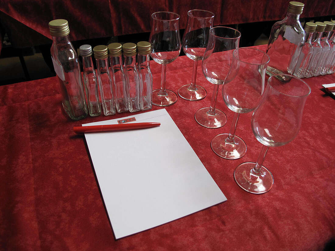 several glasses, empty sample bottles, paper and pencil